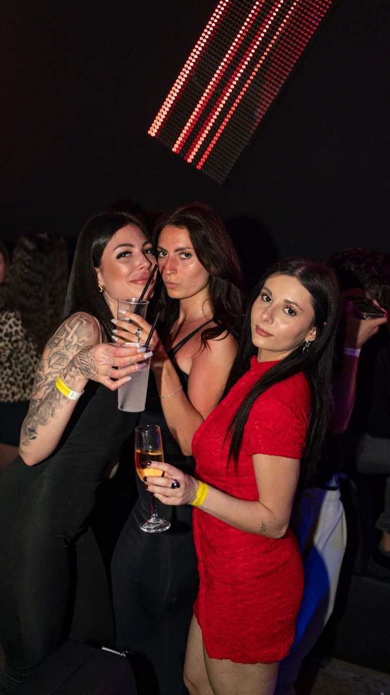 Due amiche vicine, una beve con la cannuccia
